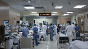Busy hospital ward with medical staff and patients.